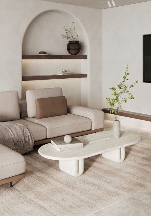 A modern living room with a beige sectional sofa, a white coffee table, wooden shelves, and minimalist decor, including a potted plant on the table.